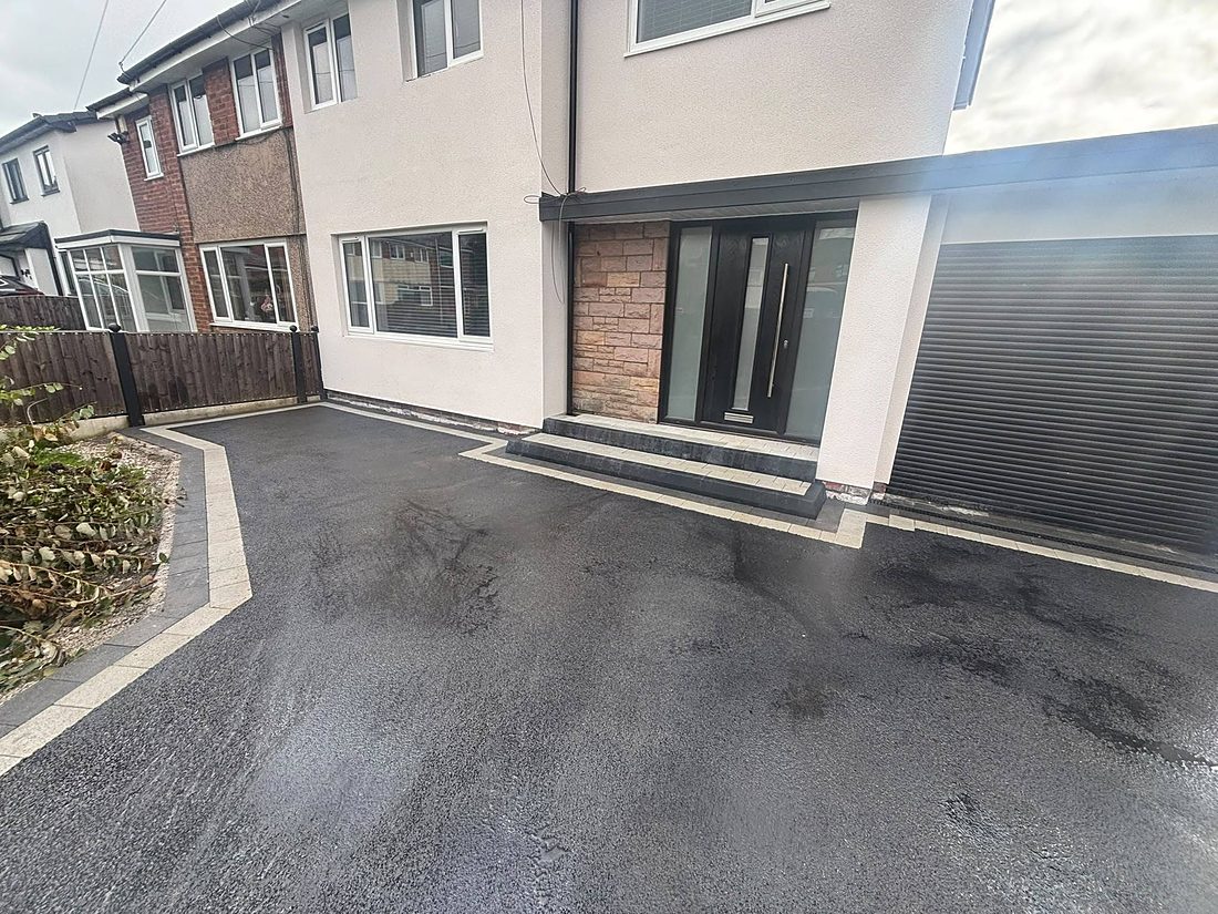 A smooth tarmac driveway finished with a block-paved border